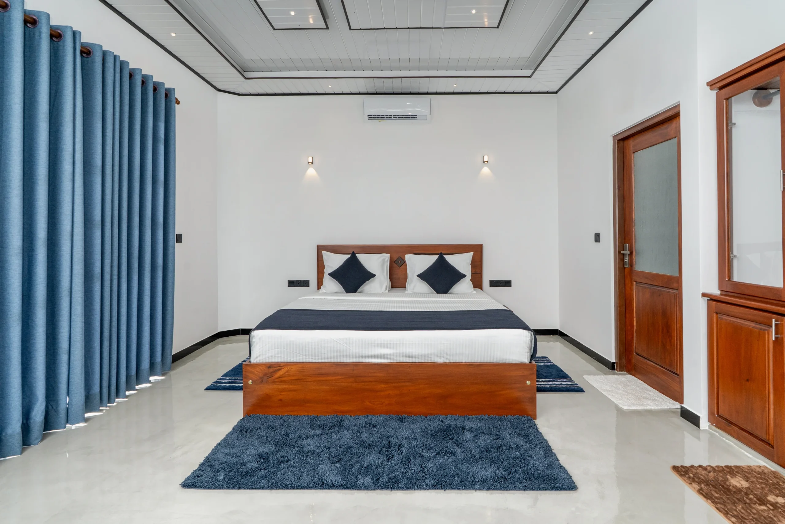 Deluxe Double Room interior at Arice Unawatuna with modern design, blue accents, and king-size bed