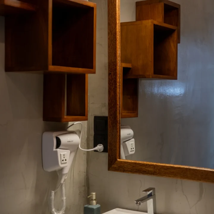 Cozy bathroom vanity with square sink and wall mirror at Arice Eco Villa