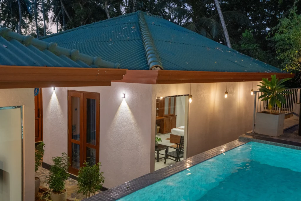 Poolside view of villa rooms with warm exterior lighting – Arice Eco Villa Unawatuna