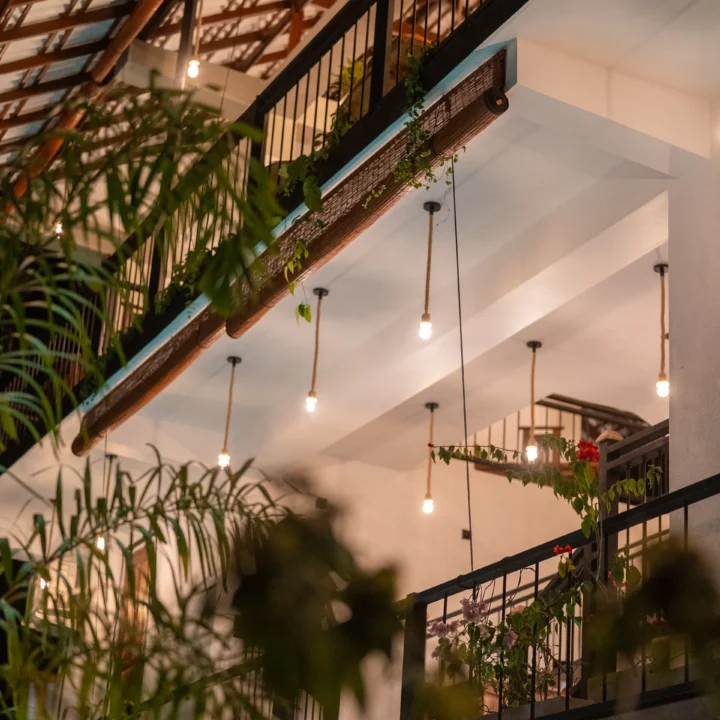 Outdoor corridor and lit walkway leading to villa rooms at Arice Eco Villa