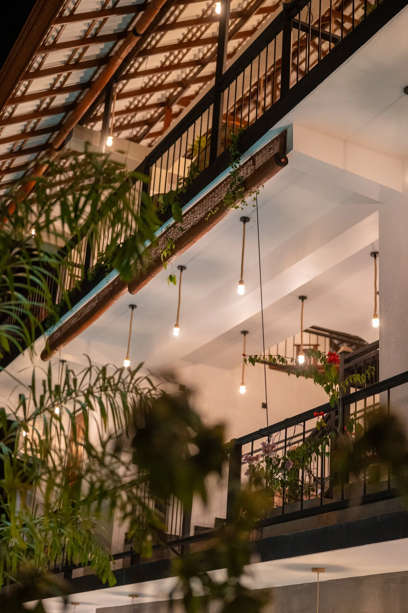 Outdoor corridor and lit walkway leading to villa rooms at Arice Eco Villa