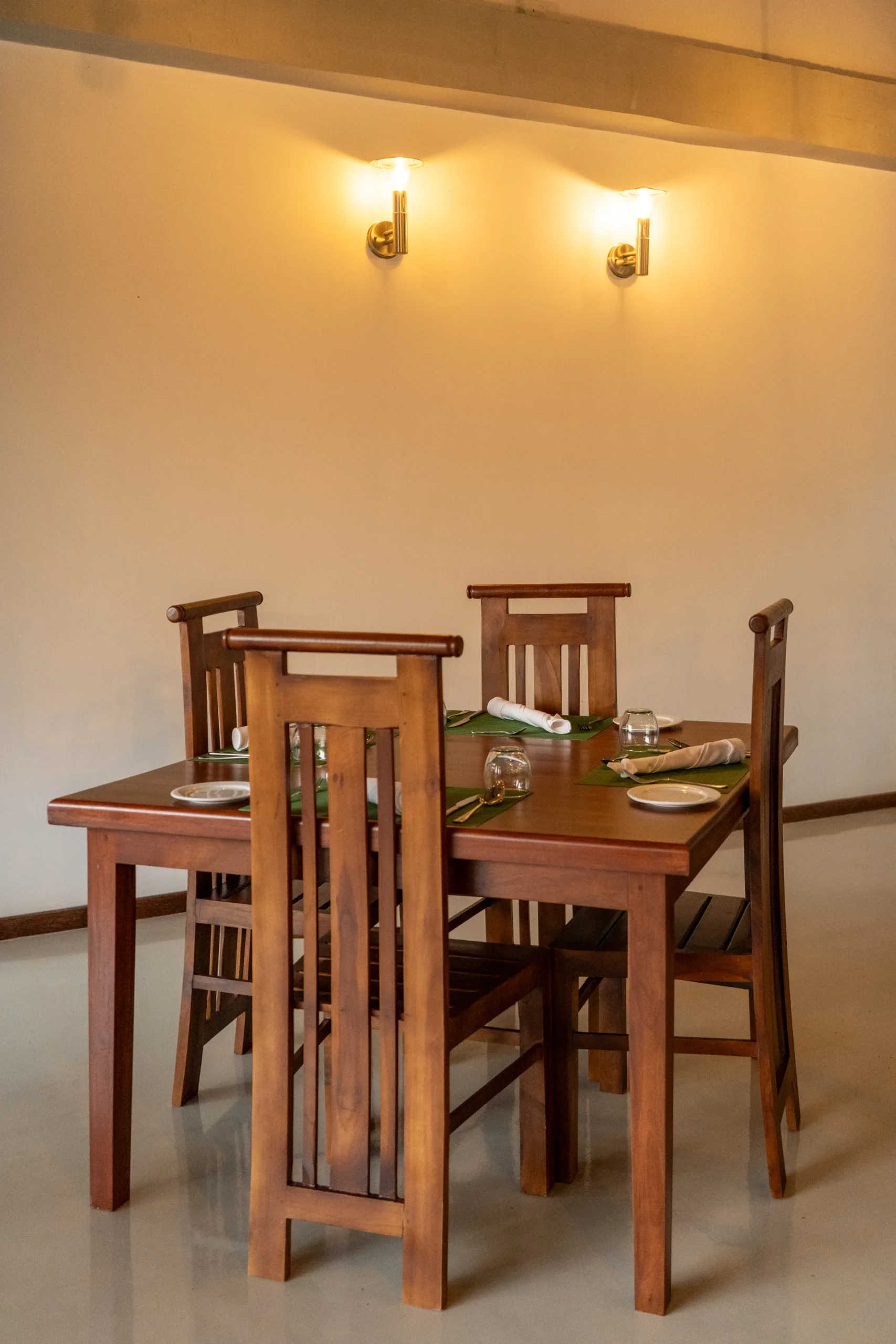 Arice Unawatuna dining area with wooden table setup and warm ambient lighting.