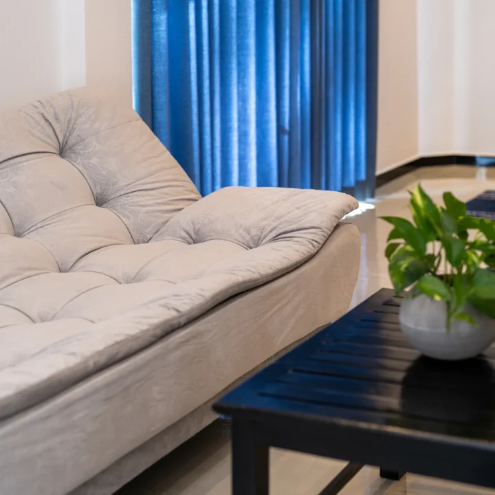 Soft grey sofa and coffee table in a relaxing hotel room corner