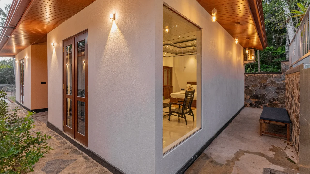 Exterior night view of villa unit with warm lighting and walkway at Arice Eco Villa