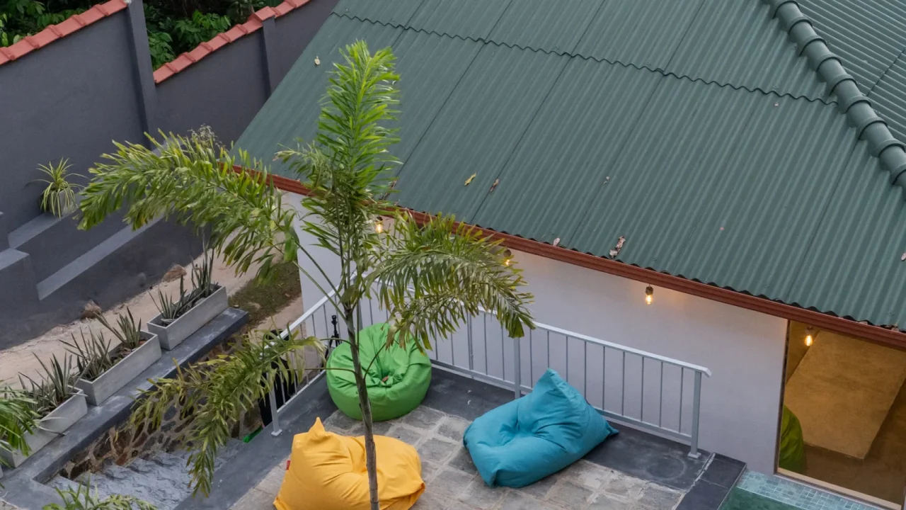 Relaxing poolside area with sun loungers and colorful beanbags at Arice Eco Villa