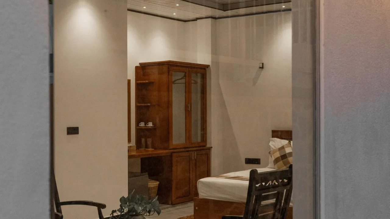 Warm evening view inside the villa room seen through a large window at Arice Eco Villa