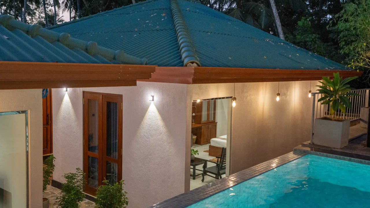 Poolside view of villa rooms with warm exterior lighting – Arice Eco Villa Unawatuna