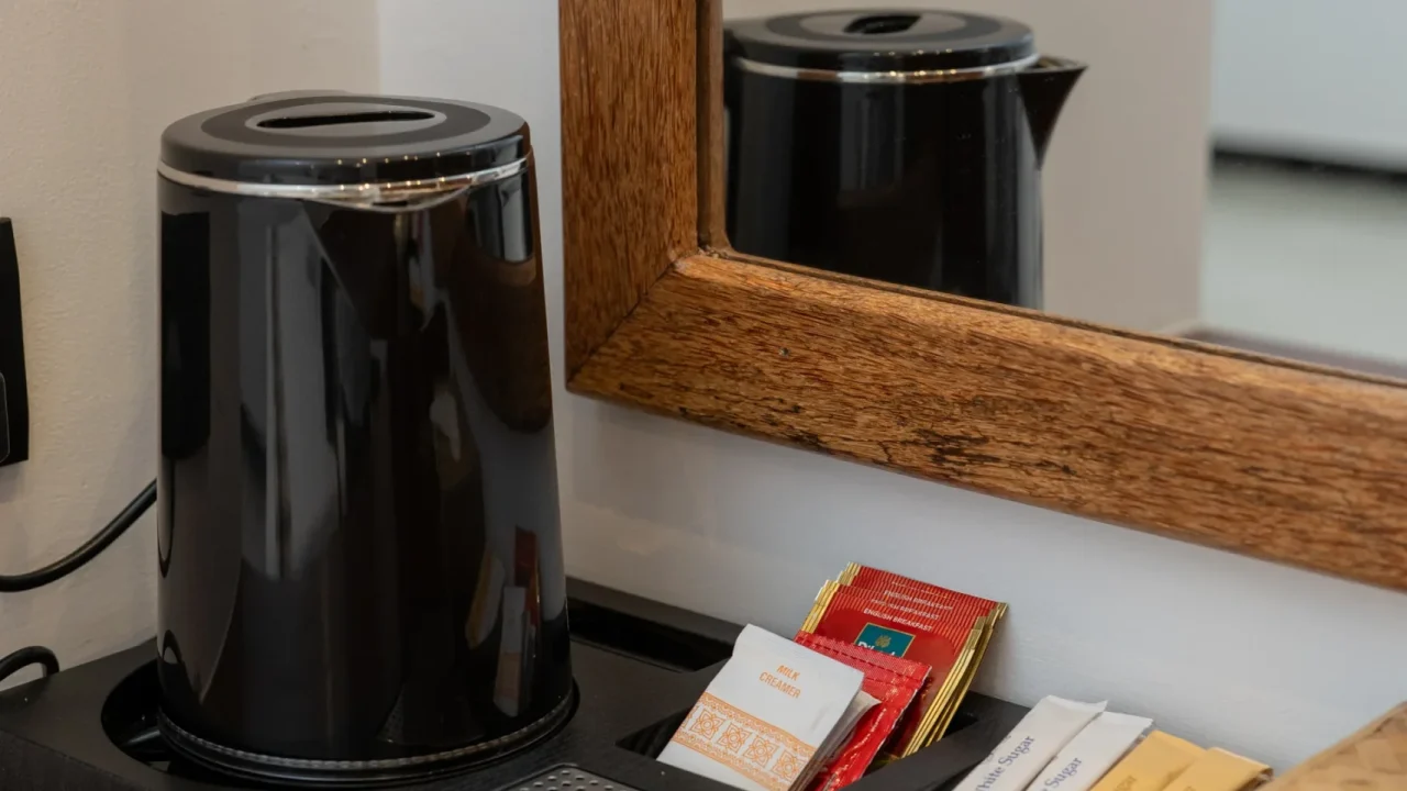 Tea and coffee amenities with electric kettle in villa room at Arice Eco Villa